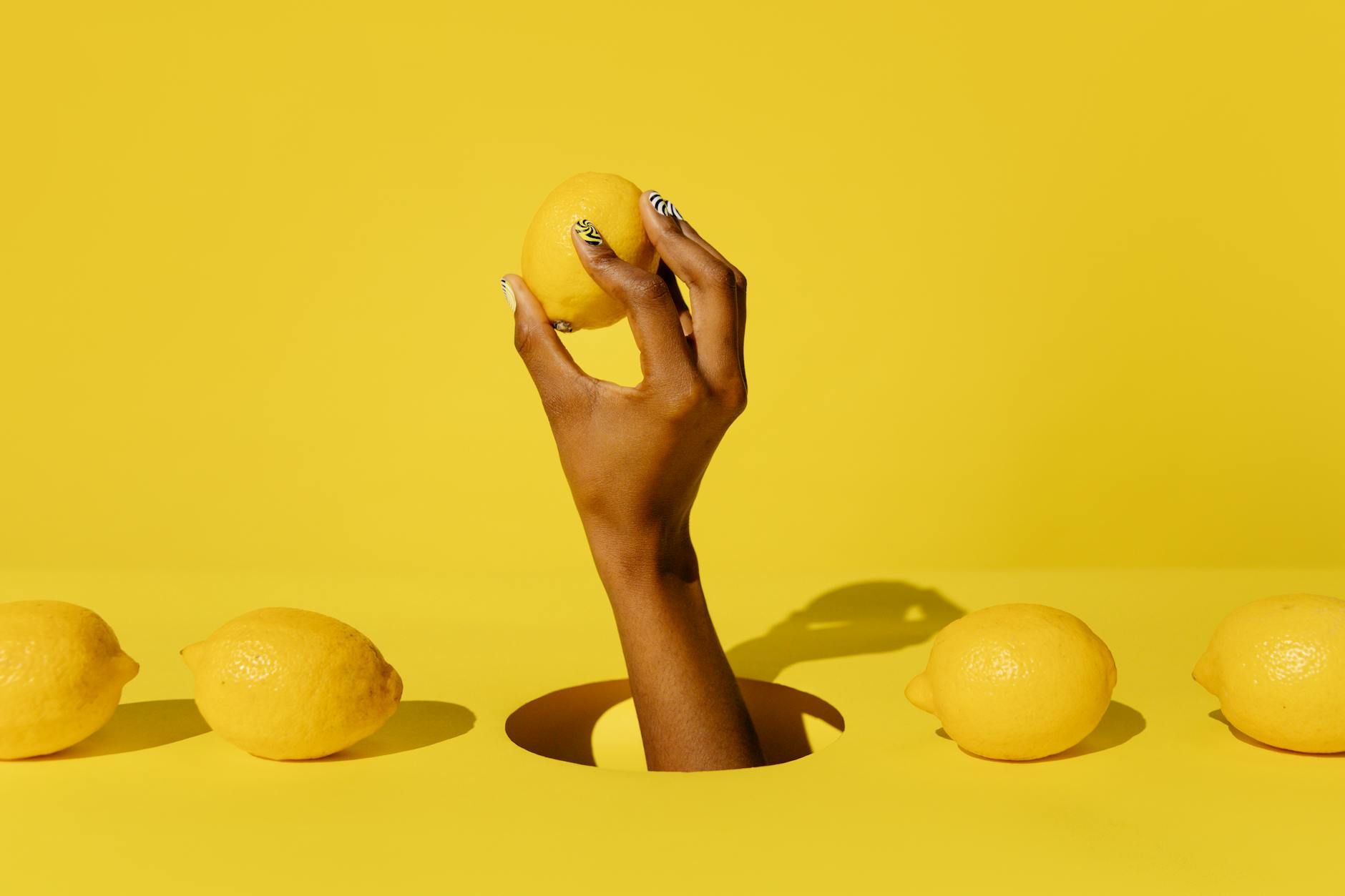 Yellow silicone vibrator surrounded by peeled bananas on a yellow background